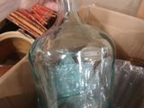 a person holding a glass bottle in a box