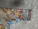 a blue and gold jacket on a concrete floor