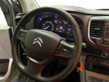 the interior of a car with a steering wheel and dashboard controls