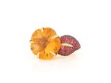 a close up of a ring with a yellow topaz and pink sapphires