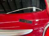 a red car with a sticker on the back of it