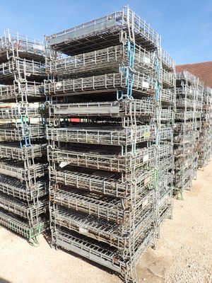 a large pile of cages that are stacked on top of each other