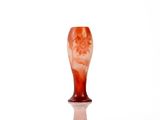 a glass vase with a red and white design on it