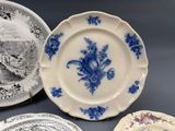 several plates with blue and white designs on them on a table