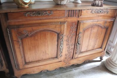 a wooden cabinet that has a clock on top of it