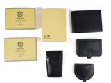 the contents of a wallet, wallet case, and other items are laid out on a white surface