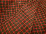 red and green plaid fabric with a black and white checkered pattern