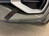 a sticker on the front bumper of a car
