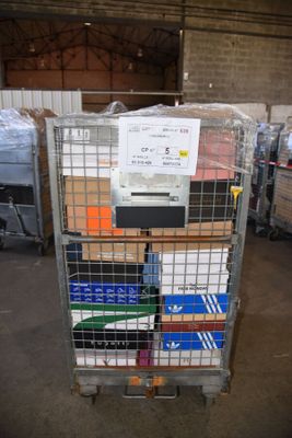 a metal cart with many boxes on it in a warehouse