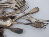 a lot of spoons and forks on the table