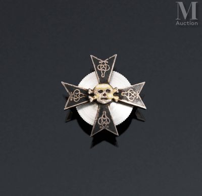a cross with a skull on it on a black surface