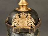 an old helmet with a golden crown on top of it