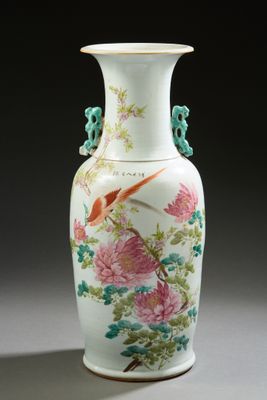 a white vase with a bird and flowers on it