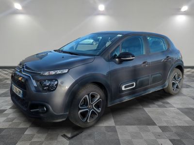 a grey citrole parked on a checkered floor in a garage