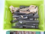 a green container filled with empty bottles and papers