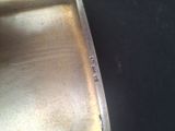 a close up of a metal pan with a knife in it