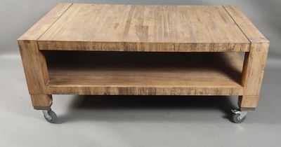 une petite table en bois à roulettes posée à même le sol