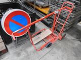 a red and blue sign on a cart in a warehouse