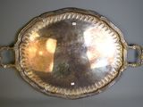 a silver tray with handles and a mirror on the wall