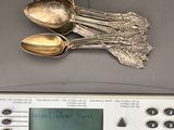 silver spoons and spoon spoons on top of a digital scale