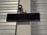 a picture of a black speaker on a metal wall