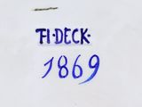 a close up of a white plate with blue writing on it