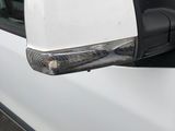 an image of a side view mirror of a white car