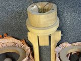 two candles that are sitting on a wooden stand