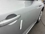 a close up of a car door handle with a sticker on it
