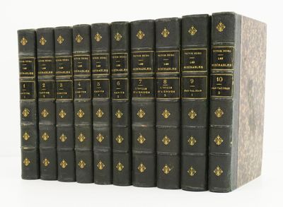 the books are lined up in a row on a white surface