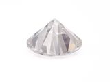 a close up of a diamond on a white surface
