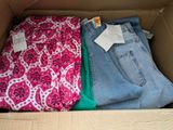 two pairs of jeans in a box on the floor