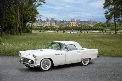 a white car that is parked on the side of the road
