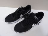 pair of black and white running shoes on a white surface