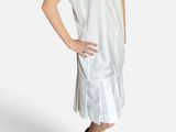 pregnant woman in a white dress standing with her hands on her hips
