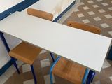 a table and two chairs in the corner of a room