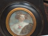 a picture of a woman in a dress on a table