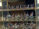 a lot of figurines that are on display in a glass case