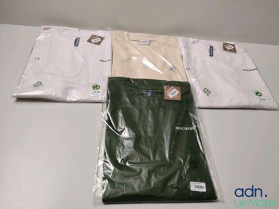 three bags of white and green shirts sitting on top of a table