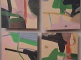 four paintings on a wall of different colors and shapes