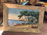une photo d'un tableau représentant une scène de plage, dans un cadre