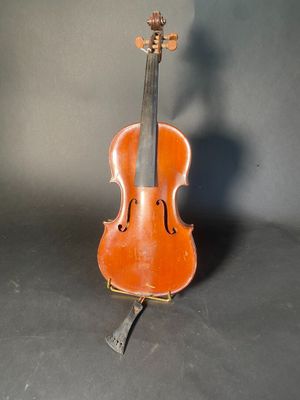 an old violin sitting on top of a table next to a gray wall