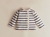a close up of a white and black striped jacket on a wall