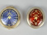 two different colored pill cases sitting next to each other