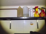 a shelf that has a lot of cleaning products on it