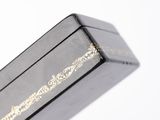 a black box with a gold design on it