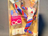 doll in the box of a barbie doll with a pair of scissors in it
