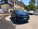 the mercedes suv is parked in front of a building in a parking lot
