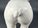 porcelain figurine of a horse on a stand on a gray background