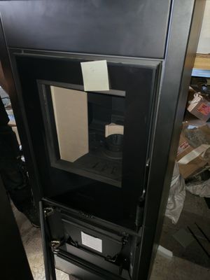 a black cabinet with a glass door in the middle of it